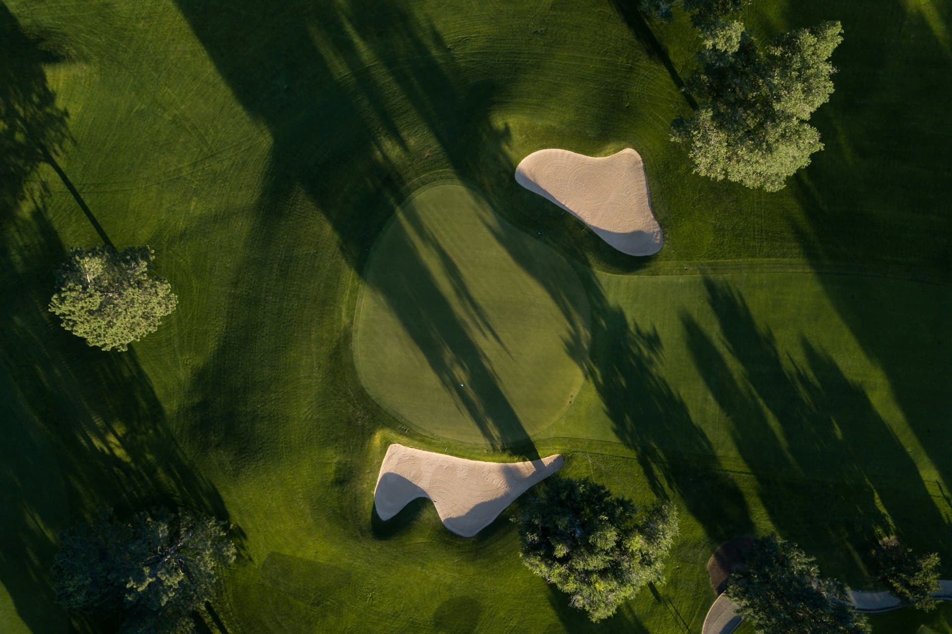 Aerial view of a golf course at golden hour